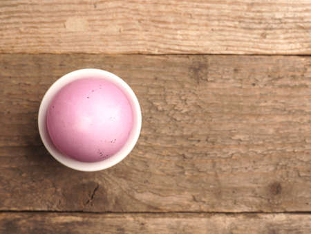 Naturally colored organic egg on a rustic table with space for text, Easter backgroundの写真素材