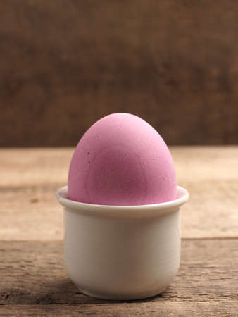 Naturally colored organic egg on a rustic table with space for text, Easter background