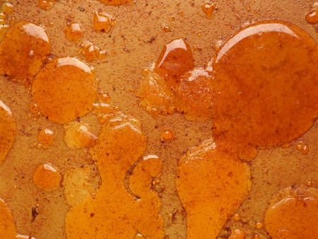 Cooled frying fat in casserole dish, view from above, unhealthy diet concept background