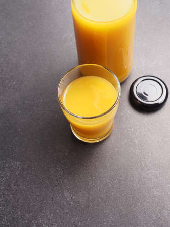 Organic orange juice on a stone table, space for text, view from above, healthy food conceptの写真素材