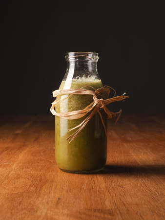 Healthy vegetable fruit smoothie from organic ingredients on a wooden kitchen table