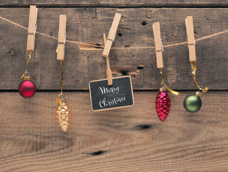 Colorful Christmas balls on a line with a small blackboard. Christmas card or invitation backgroundの写真素材