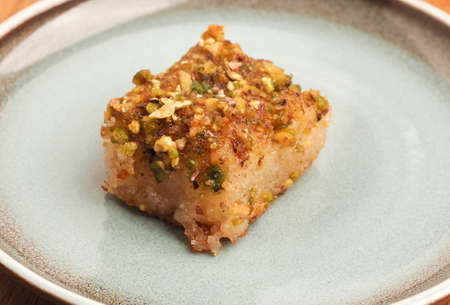 Syrian semolina cake with sugar syrup, tasty Harisse on a blue ceramic plate, Syrian dessertの写真素材