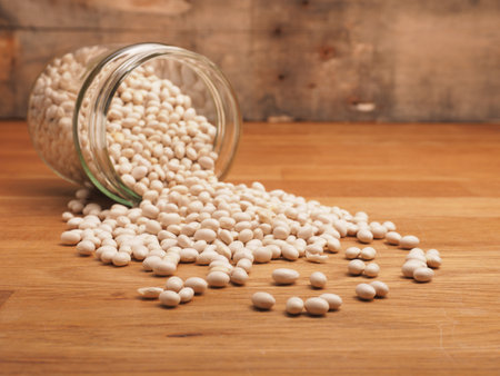 White beans in a canning jar on a kitchen table, healthy organic food concept