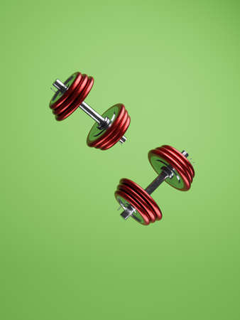 Two red metal dumbbells on a green background with space for your text or image, 3d renderingの写真素材