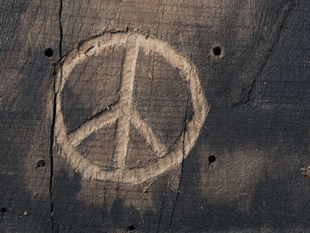 The peace symbol carved in wood with chisels. Peace concept, global solidarityの写真素材