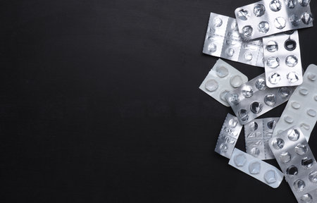 Empty tablet packs on a board with free space for your text, pill abuse, addiction concept, healthy lifestyle.の写真素材