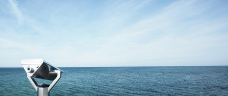Binoculars on a sea bridge, Baltic sea on a summer day, panorama scene with space for text on right sideの写真素材