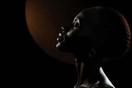 an african woman is silhouetted against a dark backgroundの素材