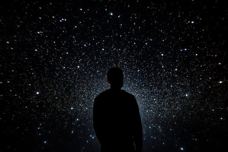 a man standing in front of a star filled skyの素材