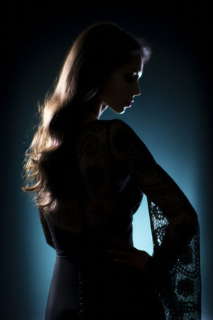 a woman in a black dress standing in front of a blue lightの素材