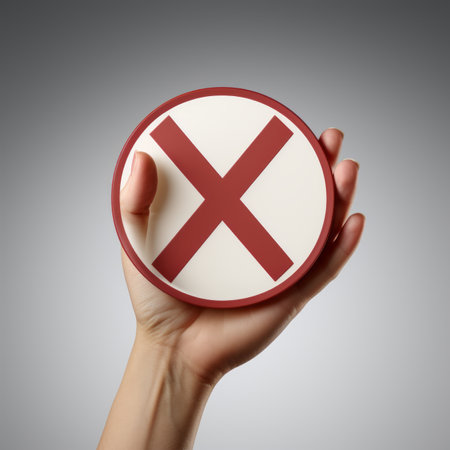 a person holding a red and white sign with an x on itの素材