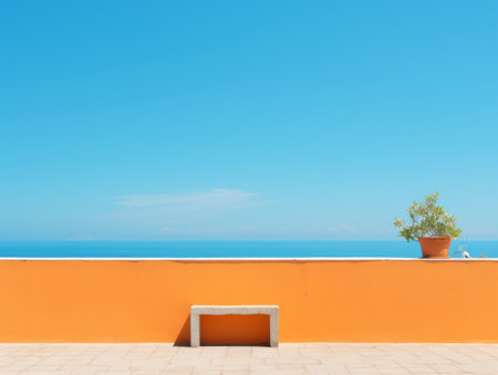 an orange wall with a potted plant sitting on itの素材