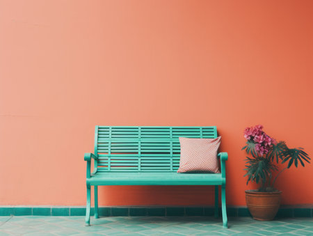 an orange wall with a green bench and a potted plantの素材