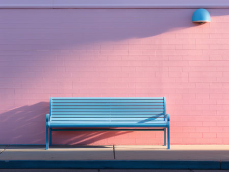 a blue bench sitting in front of a pink wallの素材