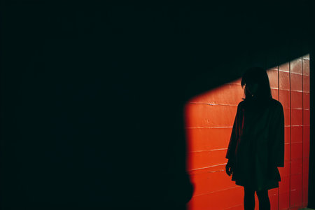 a person standing in front of a red wallの素材