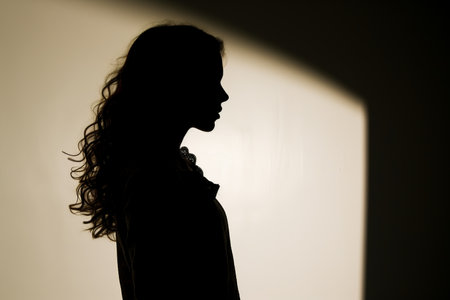 silhouette of a woman standing in front of a wallの素材
