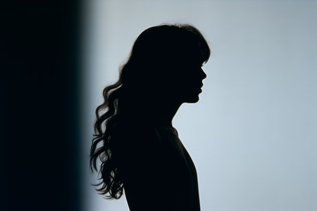 silhouette of a woman in front of a wallの素材