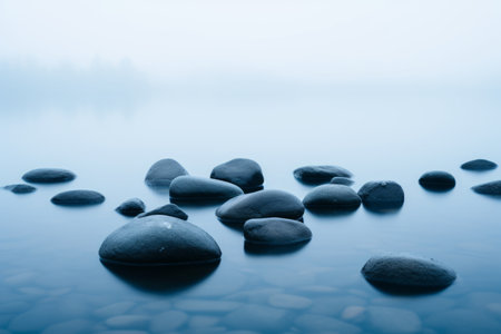 rocks in the water on a foggy dayの素材