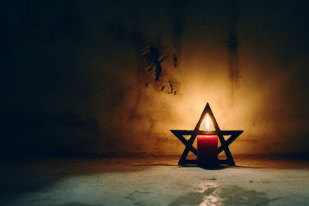 a candle is lit in front of a dark wallの素材