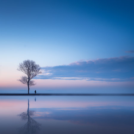 a lone tree stands in the middle of a lakeの素材