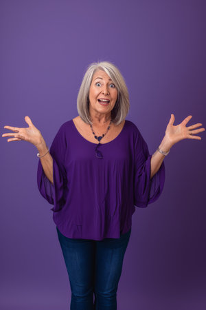 a woman in a purple shirt is standing with her hands outstretchedの素材