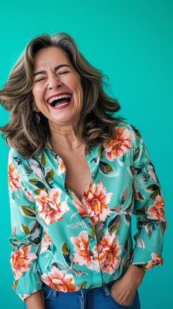 a woman laughing while wearing a floral shirtの素材