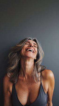 a woman with gray hair is laughing and smilingの素材