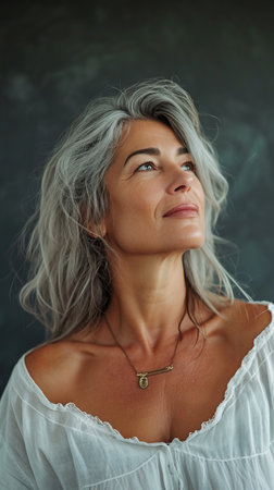 a woman with gray hair looking upの素材