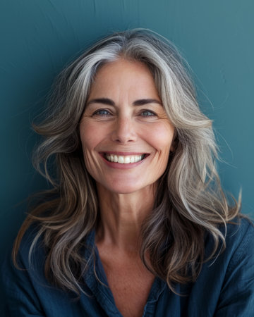 a woman with gray hair smiling and looking at the cameraの素材