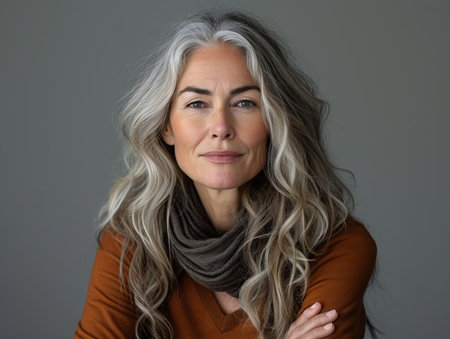 a woman with long gray hair and a brown sweaterの素材