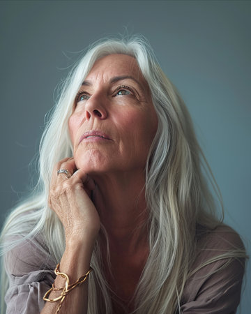 a woman with long white hair looking upの素材