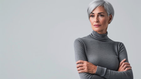 an older woman with gray hair standing with her arms crossedの素材
