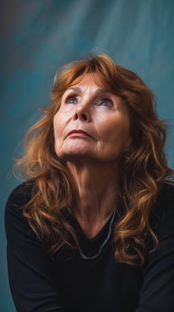 an older woman with red hair looking upの素材