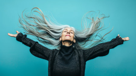 an older woman with long hair in the airの素材