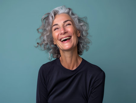 an older woman with gray hair laughing and smilingの素材