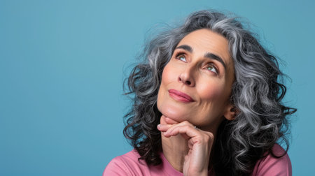 an older woman with gray hair looking upの素材