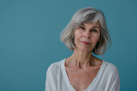 an older woman with gray hair and a white shirtの素材