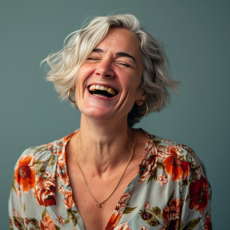 a woman laughing with her eyes closedの素材