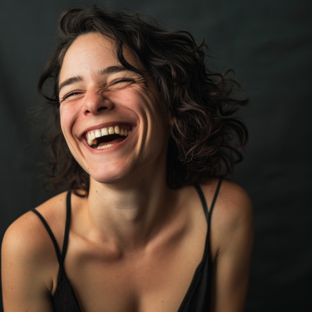 a woman with curly hair is laughingの素材