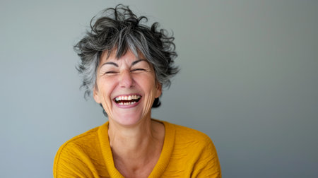 a woman with curly hair laughing and smilingの素材