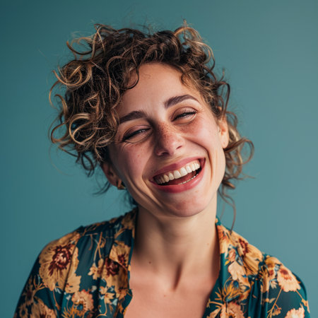 a woman with curly hair laughing and smilingの素材