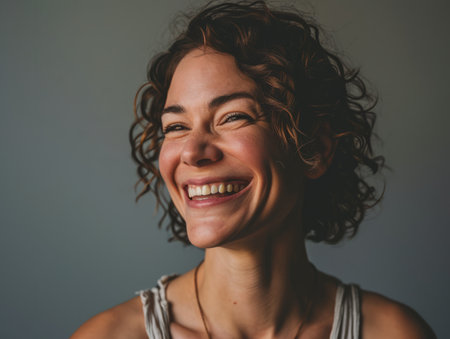 a woman with curly hair smilingの素材