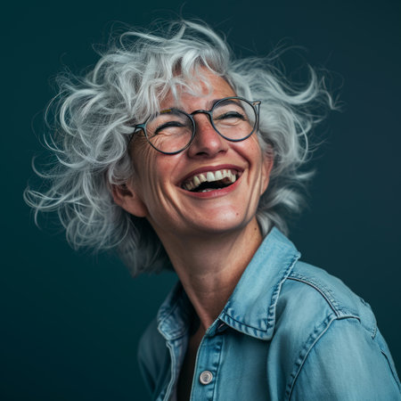 a woman with gray hair and glasses laughingの素材