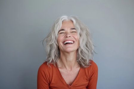 a woman with gray hair laughing and smilingの素材