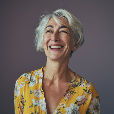 a woman with gray hair and a yellow top is smilingの素材