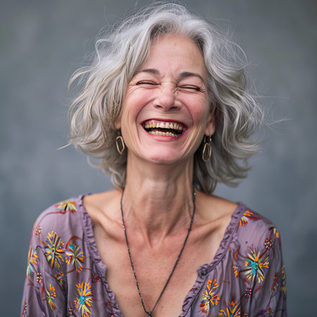 a woman with gray hair laughingの素材