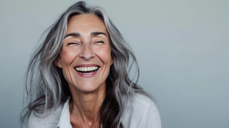 a woman with gray hair smiling and laughingの素材