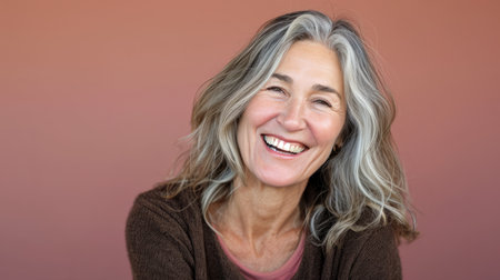 a woman with gray hair smiling and looking at the cameraの素材