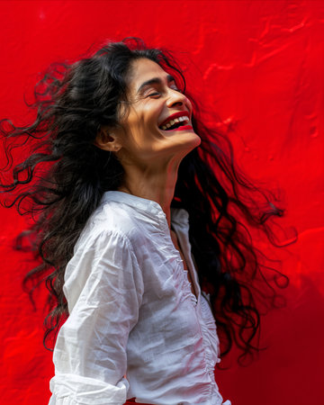 a woman with long black hair is laughing and smilingの素材